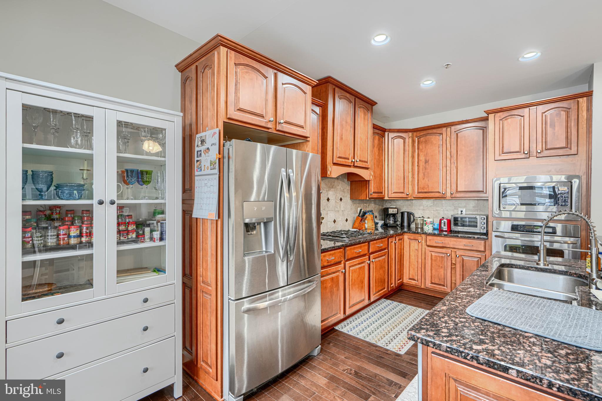 432 Grand Street Gaithersburg, MD 20878 - Photo 16 of 48 a kitchen with stainless steel appliances granite countertop a refrigerator and a stove top oven