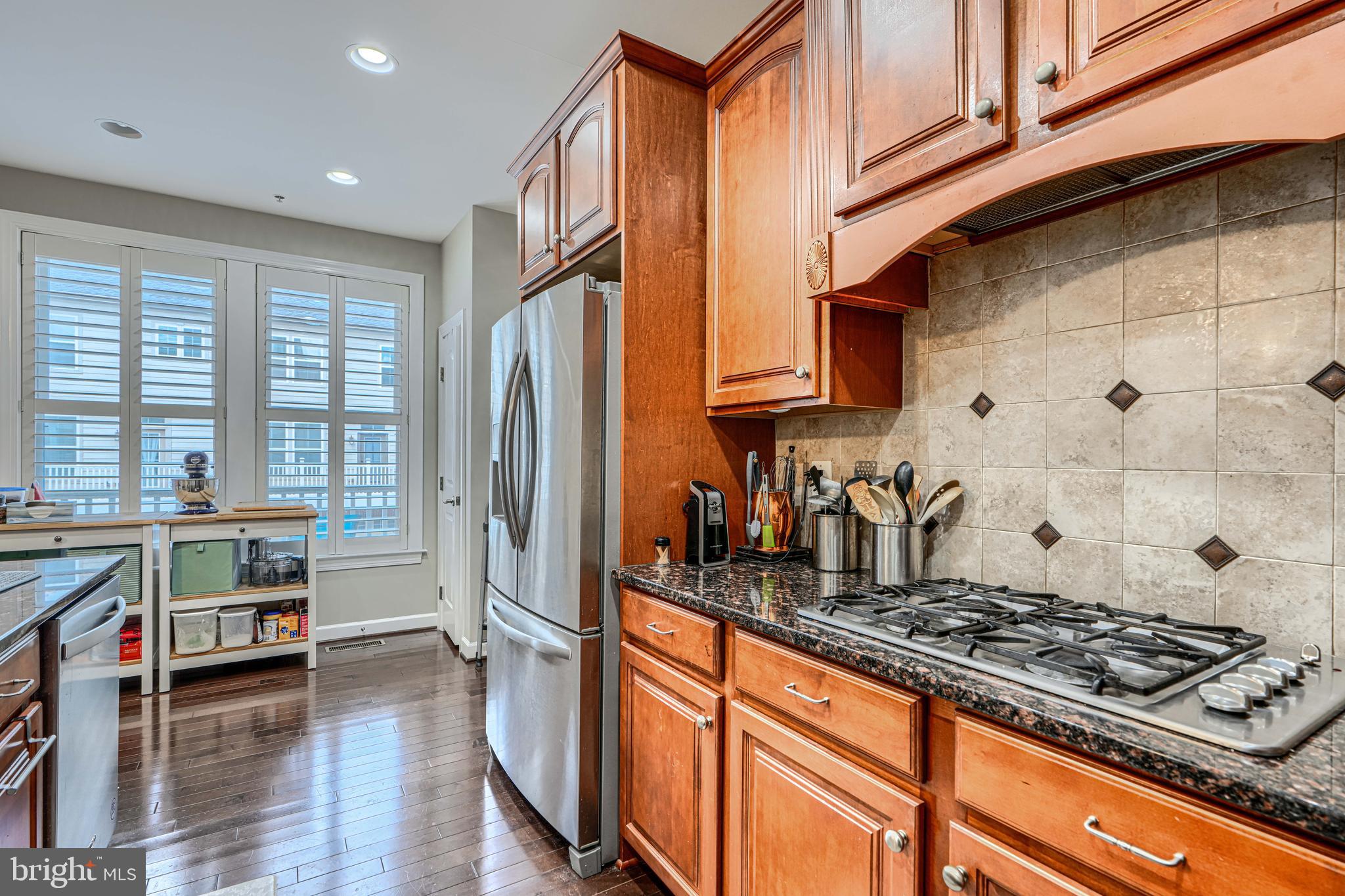 432 Grand Street Gaithersburg, MD 20878 - Photo 18 of 48 a kitchen with stainless steel appliances granite countertop a stove a sink and a refrigerator