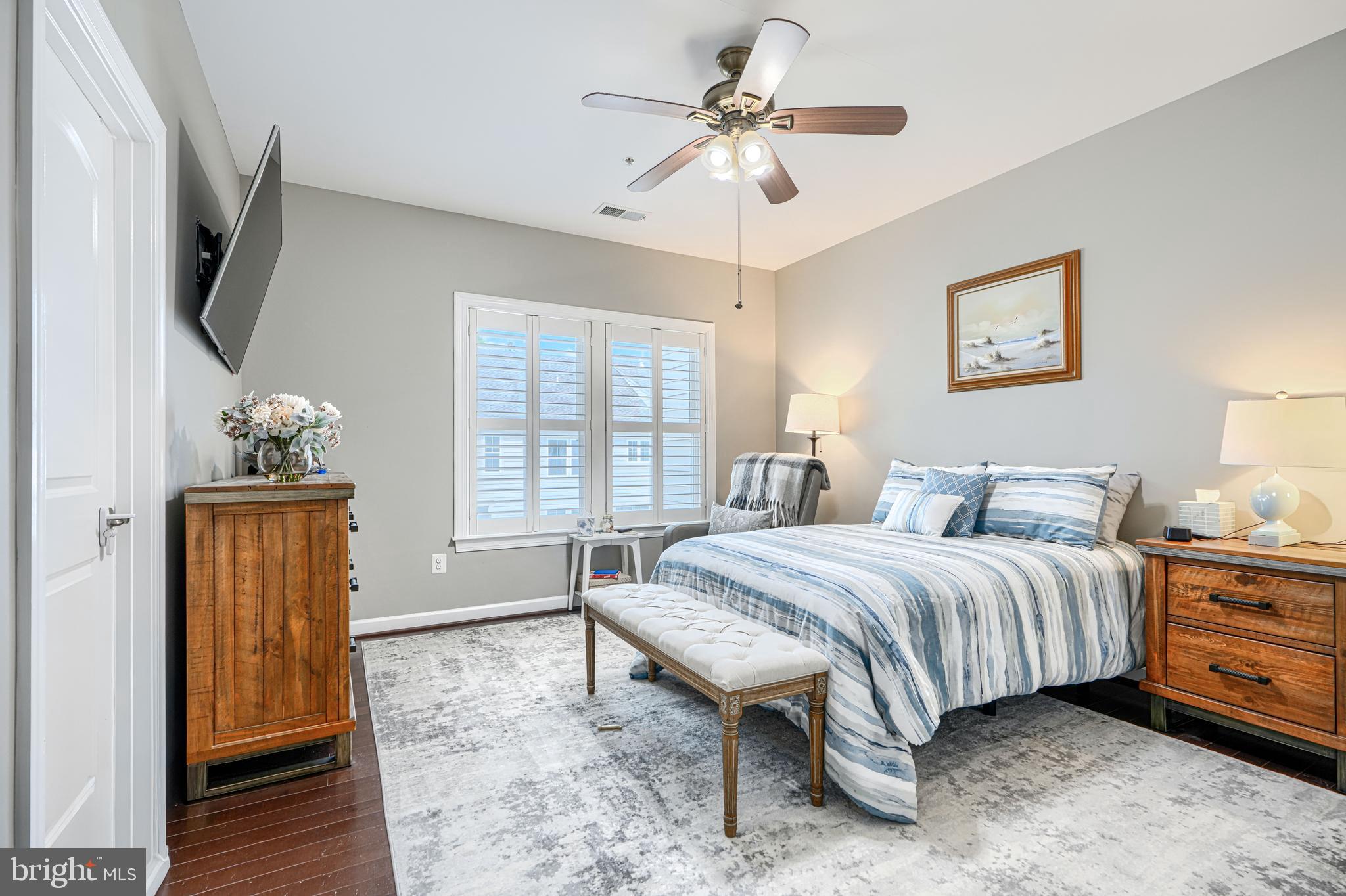 432 Grand Street Gaithersburg, MD 20878 - Photo 30 of 48 a spacious bedroom with a bed a dresser and wooden floor