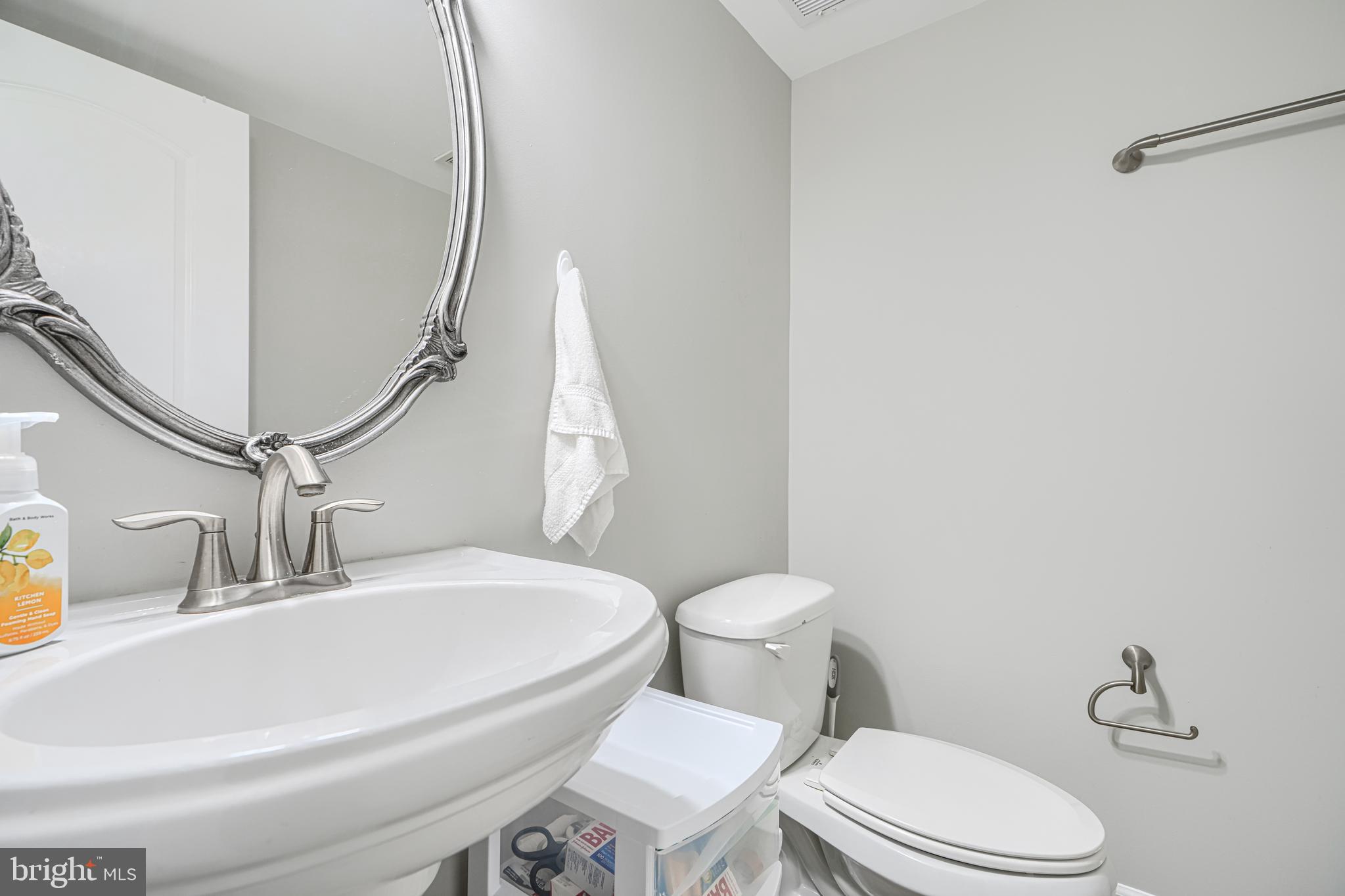 432 Grand Street Gaithersburg, MD 20878 - Photo 6 of 48 a white toilet sitting next to a bathroom sink