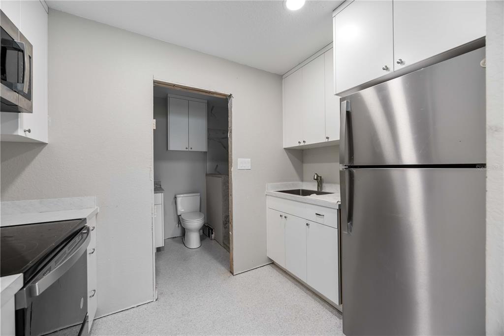 3254 Elliott Street Venice, FL 34292 - Photo 11 of 23 a kitchen with a refrigerator and a stove