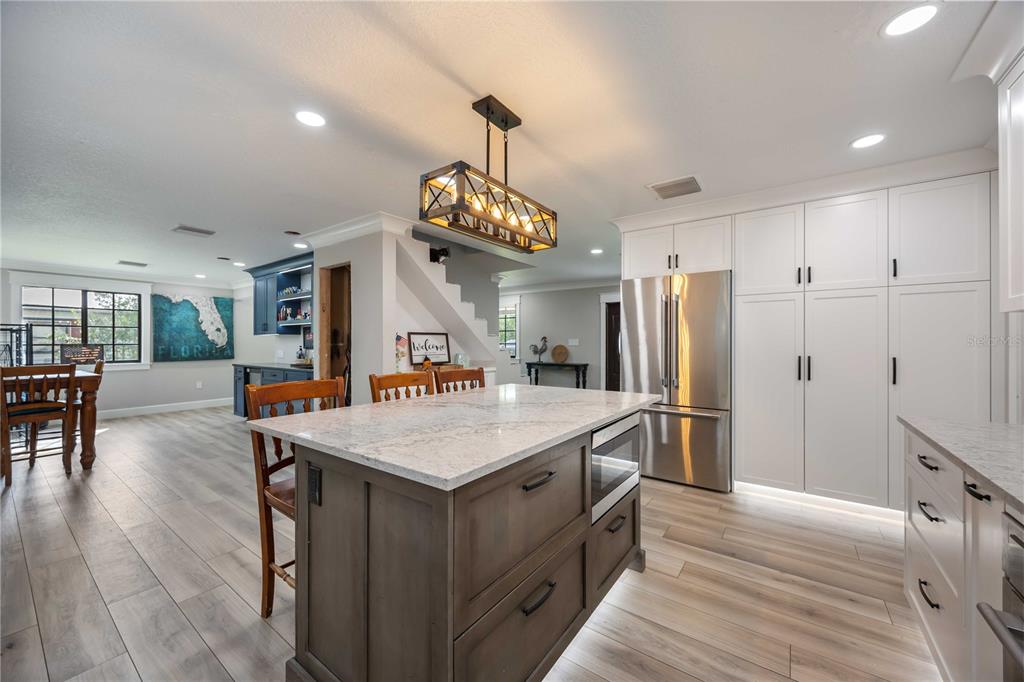 3254 Elliott Street Venice, FL 34292 - Photo 5 of 23 a large kitchen with a table and refrigerator