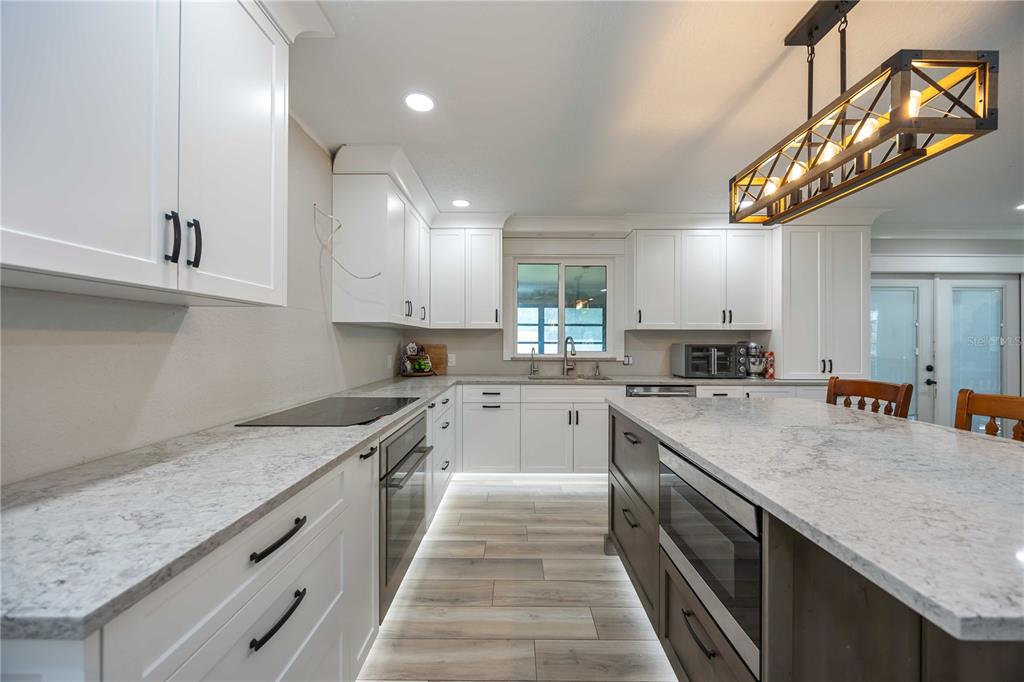 3254 Elliott Street Venice, FL 34292 - Photo 6 of 23 a kitchen with stainless steel appliances granite countertop a sink a stove and cabinets