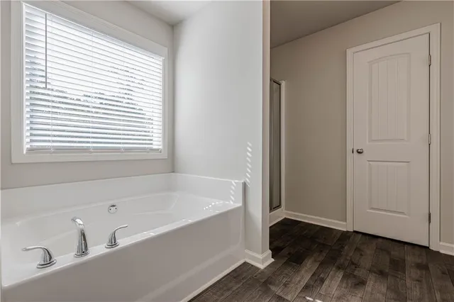 a white bath tub sitting next to a window