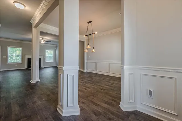 a view of a hallway with wooden floor and staircase
