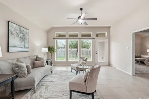 a living room with furniture and floor to ceiling windows