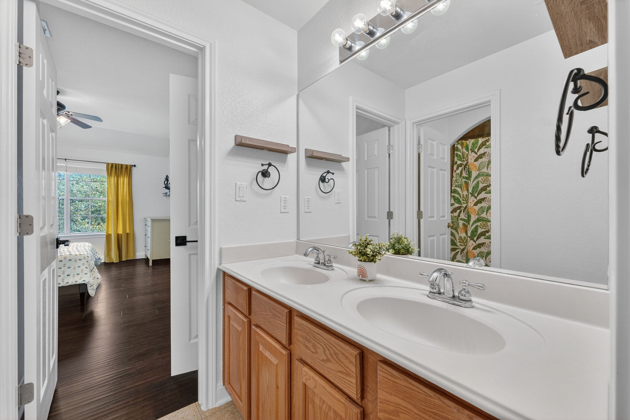 117 Lakota Pass Austin, TX 78738 - Photo 12 of 18 Full bath with double vanity, ceiling fan, light wood-style floors, and a shower with curtain