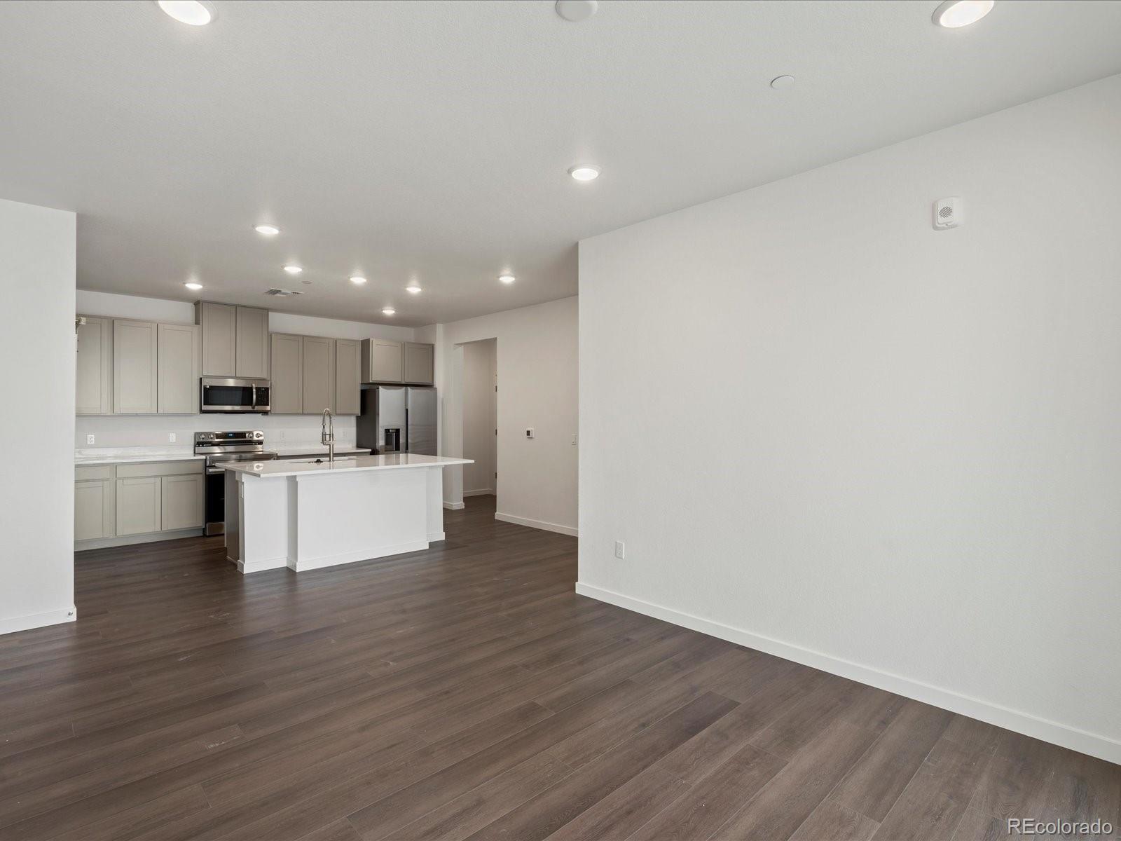 6153 North Ceylon Street, Unit 304 Denver, CO 80249 - Photo 8 of 24 a view of kitchen with wooden floor