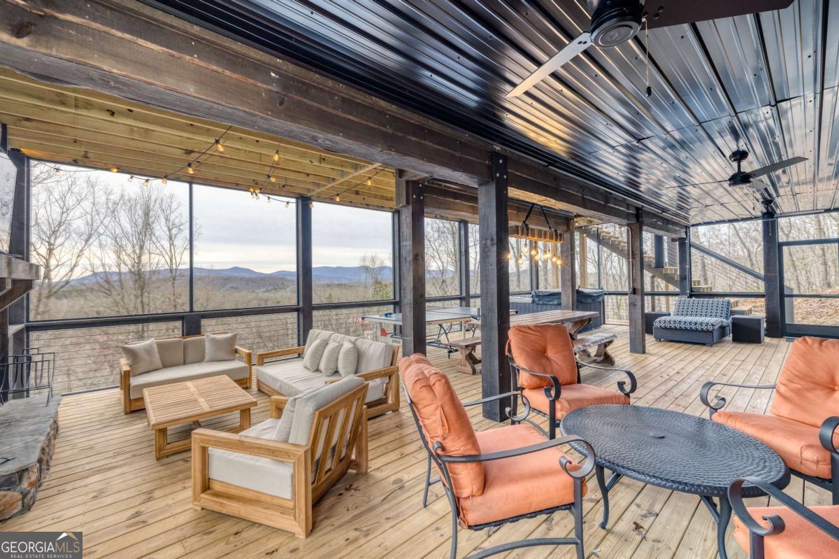 49 Chestnut Overlook Blue Ridge, Unit 11 Blue Ridge, GA 30513 - Photo 39 of 62 a outdoor space with patio the couches and chairs with wooden floor