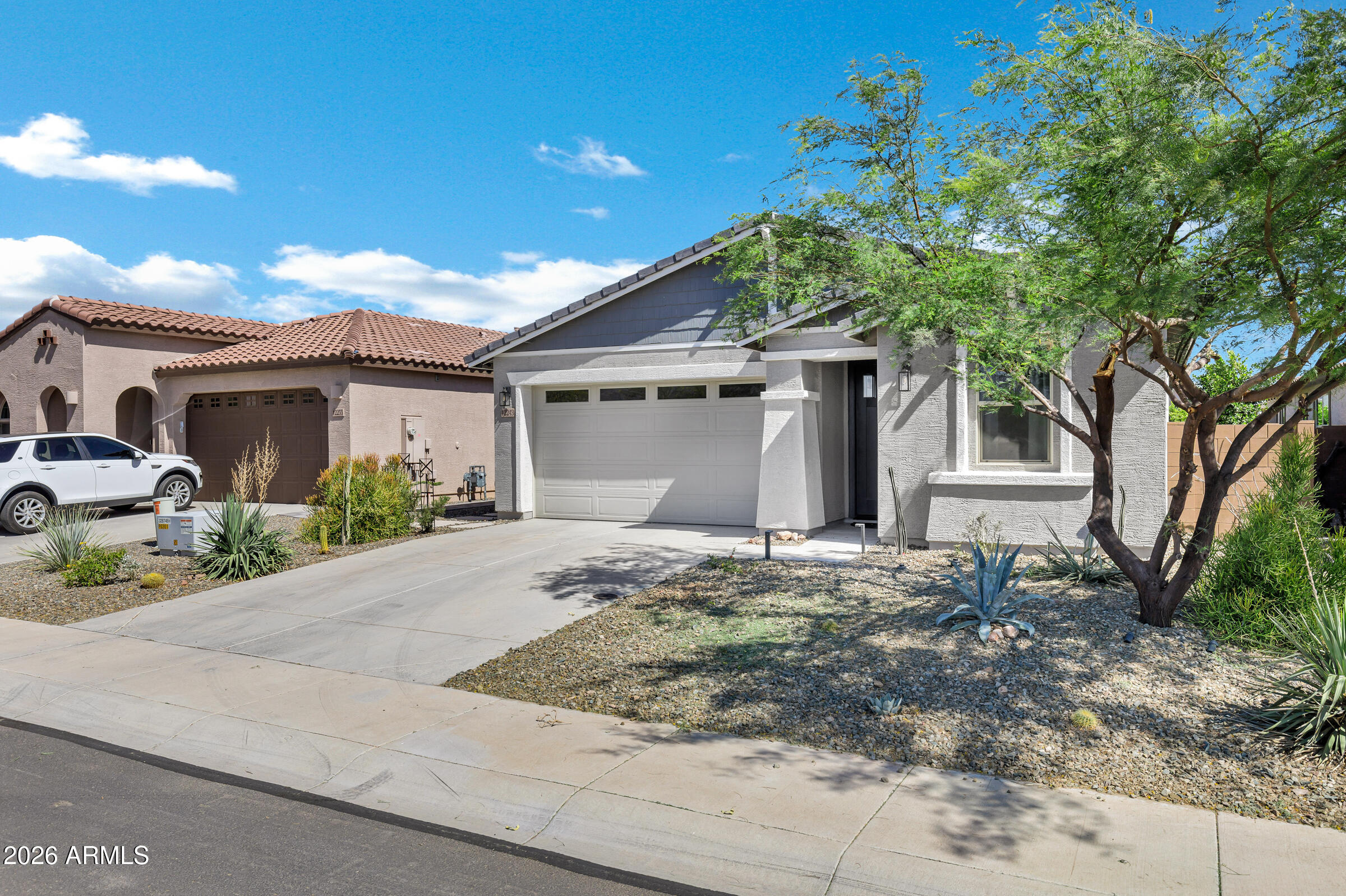 12243 East Sereno Road Gold Canyon, AZ 85118 - Photo 3 of 37 a front view of a house with a garden