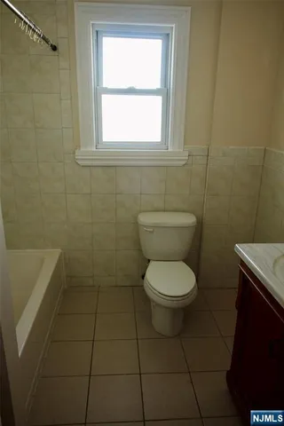 a bathroom with a toilet a sink and bathtub