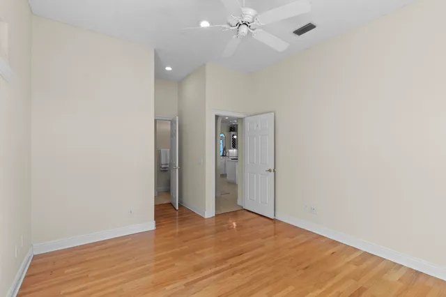 a bathroom with a granite countertop sink a mirror and a bathtub