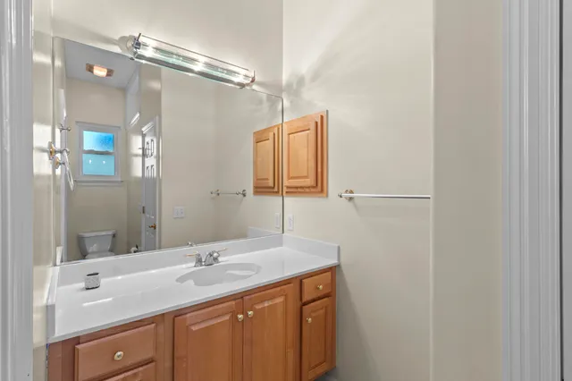 a bathroom with a shower tub mirror and toilet