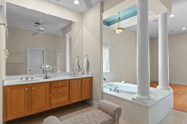 a view of a white house with a yard and large tree