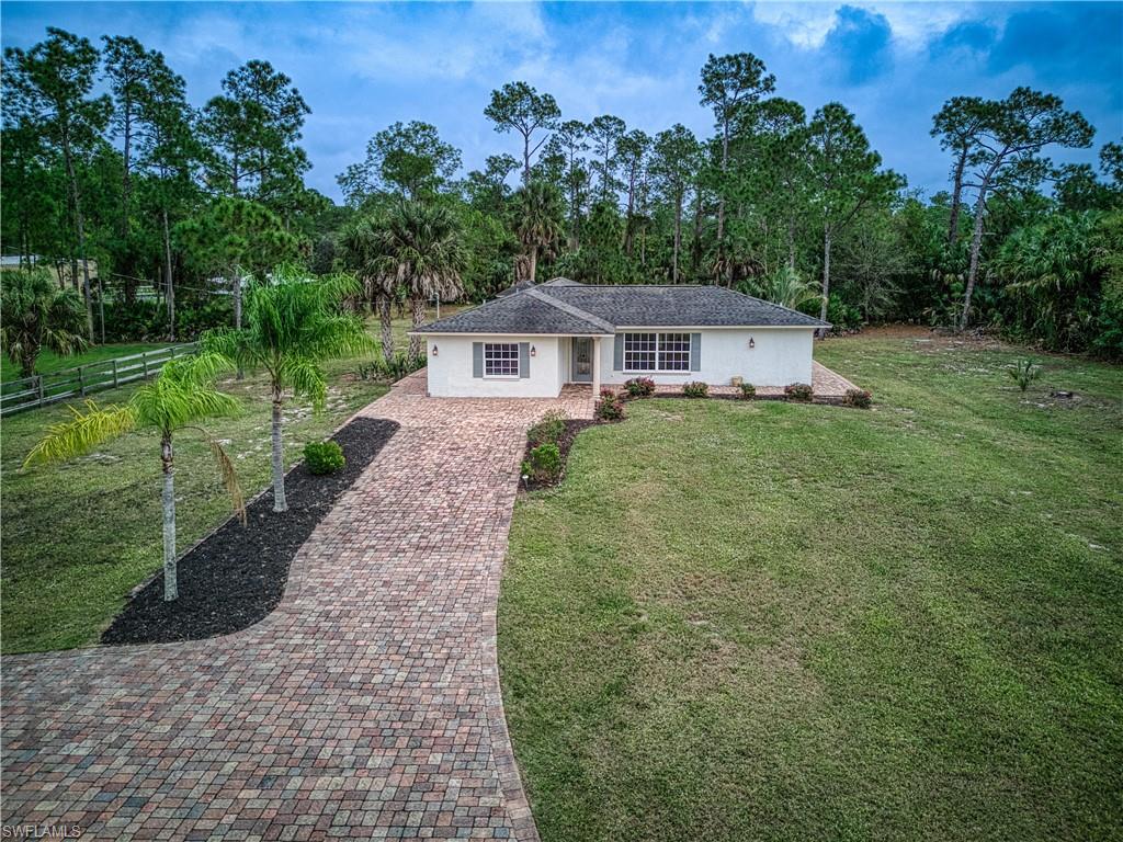 310 27th Street Southwest Naples, FL 34117 - Photo 1 of 22 Front of home, brick paver driveway