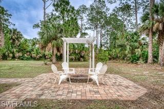 310 27th Street Southwest Naples, FL 34117 - Photo 20 of 22 Fire pit and pergola