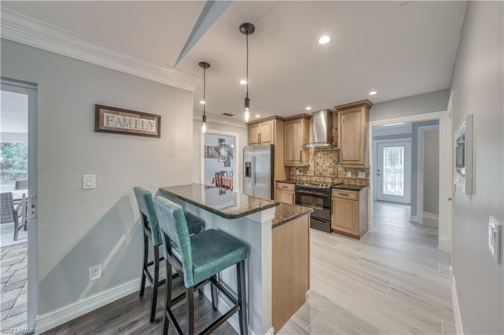 310 27th Street Southwest Naples, FL 34117 - Photo 6 of 22 kitchen with bar seating