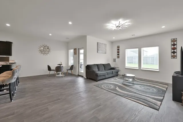 a living room with furniture and a chandelier