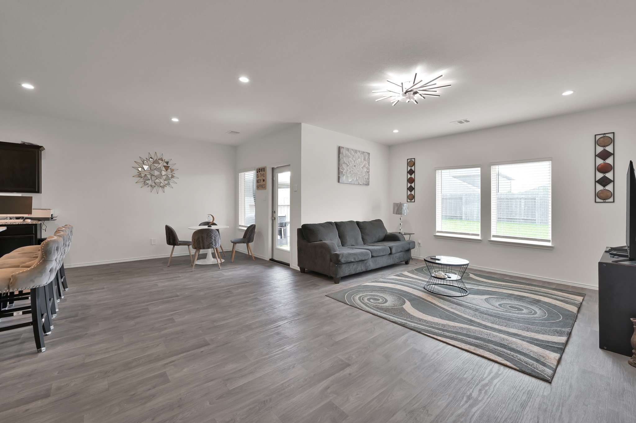 14212 Dream Road New Caney, TX 77357 - Photo 12 of 37 a living room with furniture and a chandelier