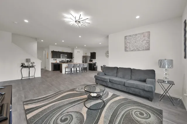 a living room with furniture and a chandelier