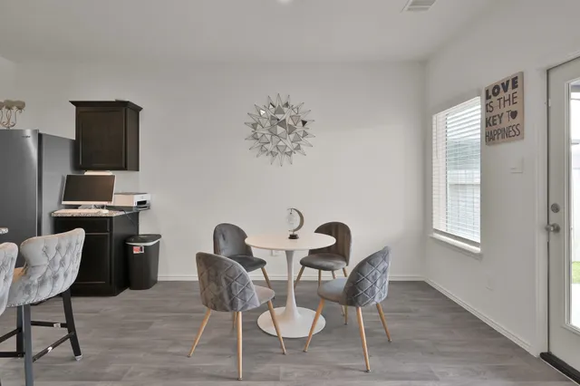 a dining room with furniture and a window