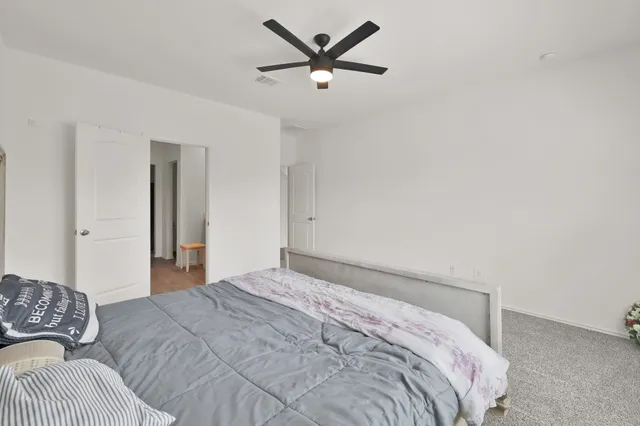 a bedroom with a bed and a large window