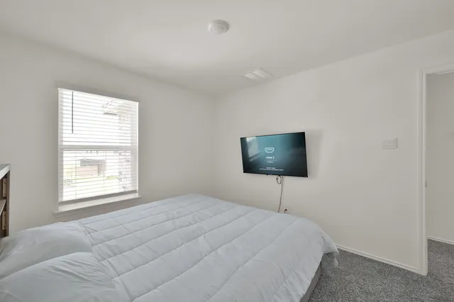 a bedroom with a bed window and a window