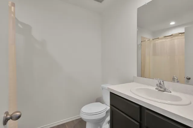 a bathroom with a sink toilet and a mirror