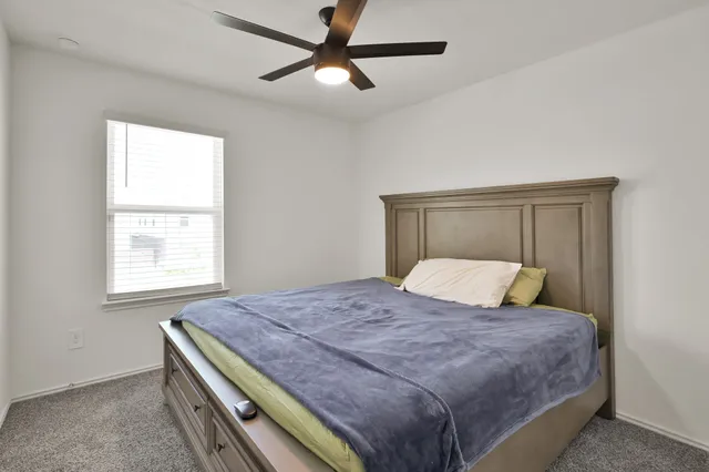 a bedroom with a large bed and a window