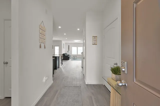 a hallway with a dining table and chairs