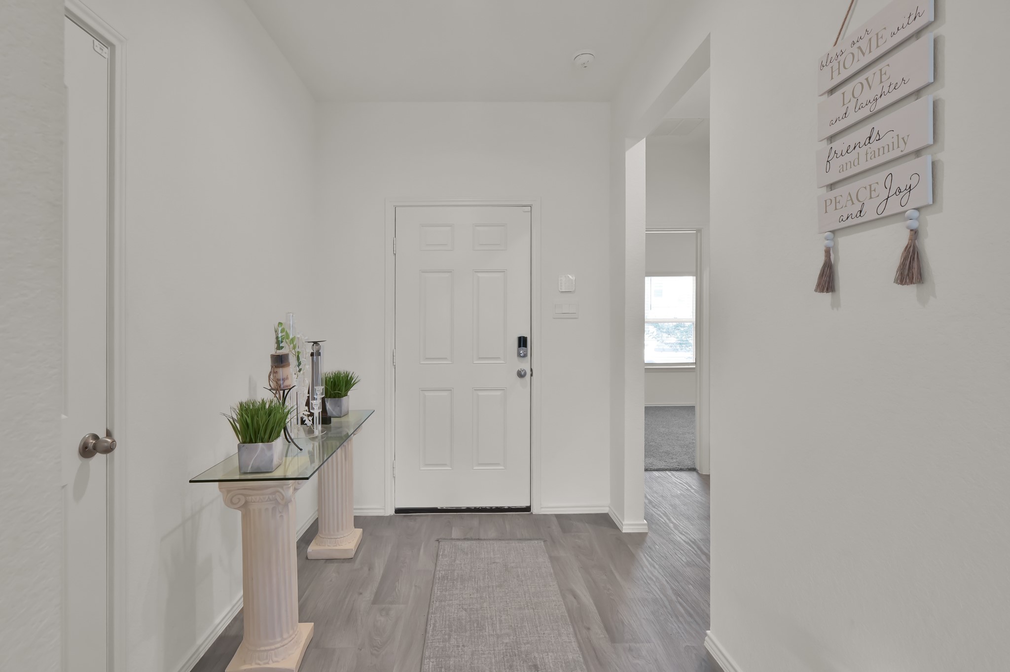 14212 Dream Road New Caney, TX 77357 - Photo 5 of 37 a view of a hallway with wooden floor and a potted plant