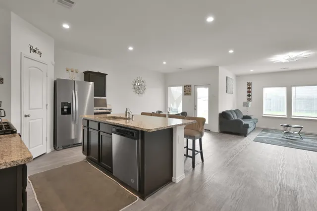 a large kitchen with stainless steel appliances lots of counter top space