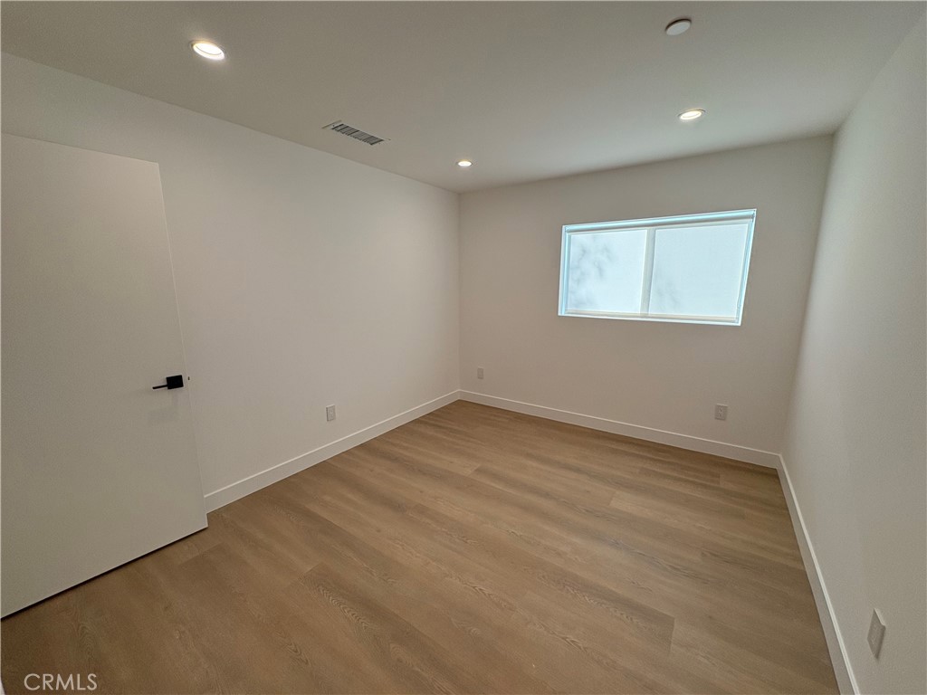 14165 Calvert Street Van Nuys, CA 91401 - Photo 12 of 21 an empty room with a workbench