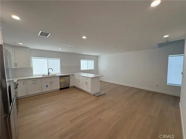 a large white kitchen with a white countertops and cabinets