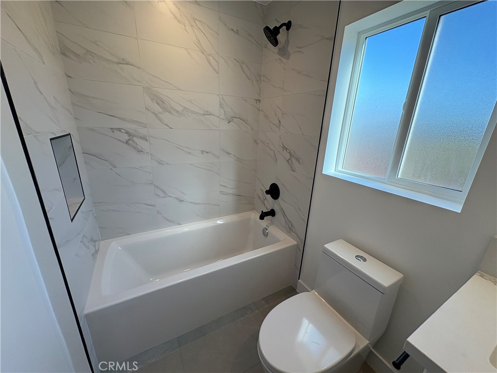 14165 Calvert Street Van Nuys, CA 91401 - Photo 5 of 21 a white toilet sitting next to a bath tub