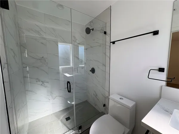 a bathroom with a toilet and a shower