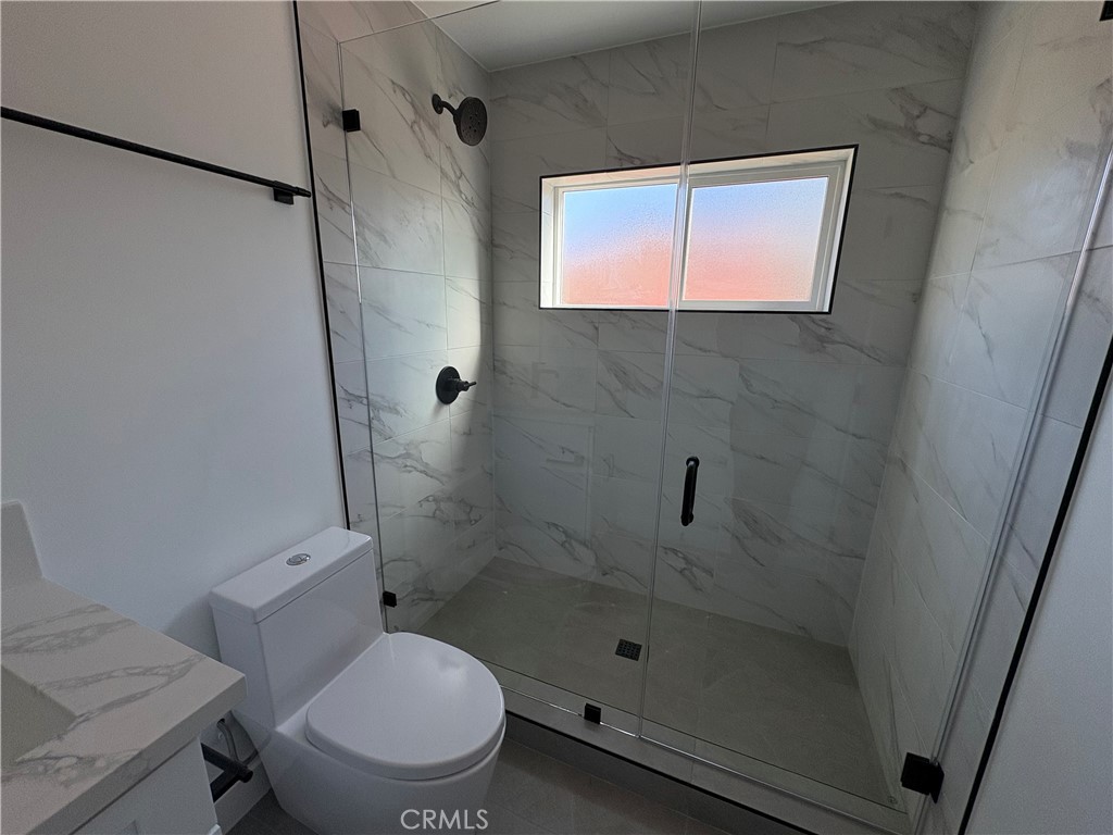 14165 Calvert Street Van Nuys, CA 91401 - Photo 10 of 21 a bathroom with a toilet and a shower