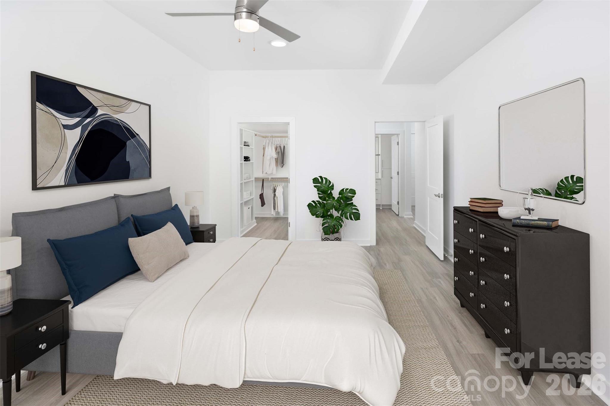 909 Camden Grandview Road, Unit B6A Charlotte, NC 28202 - Photo 20 of 23 a bedroom with a bed and a chandelier