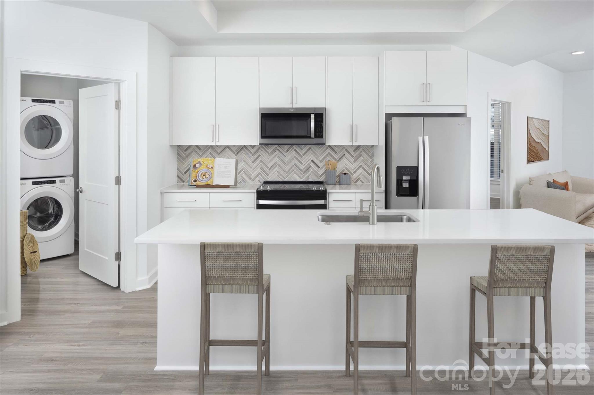 909 Camden Grandview Road, Unit B6A Charlotte, NC 28202 - Photo 10 of 23 a kitchen with stainless steel appliances a microwave a stove and white cabinets