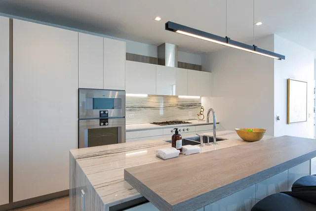 a kitchen with a sink a refrigerator and wooden cabinets