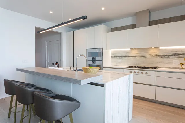 a kitchen with stainless steel appliances granite countertop a sink and a stove