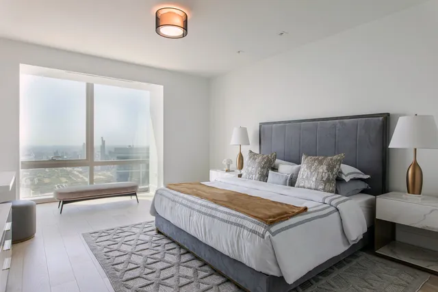 a bedroom with a large bed and a table