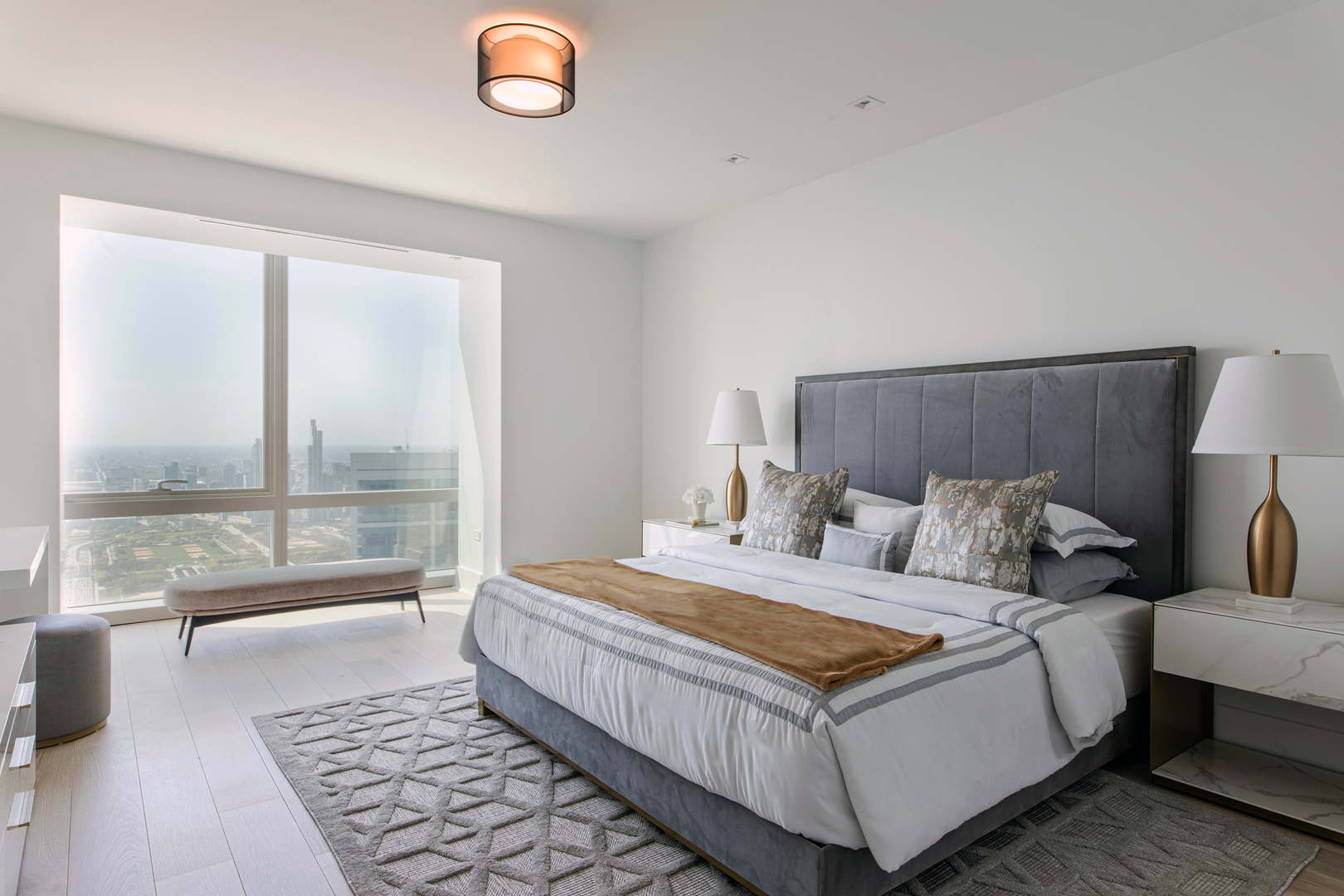 363 East Wacker Drive, Unit 6603 Chicago, IL 60601 - Photo 17 of 21 a bedroom with a large bed and a table