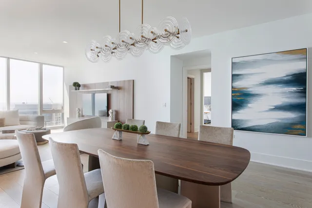 a view of a dining room with furniture wooden floor and chandelier