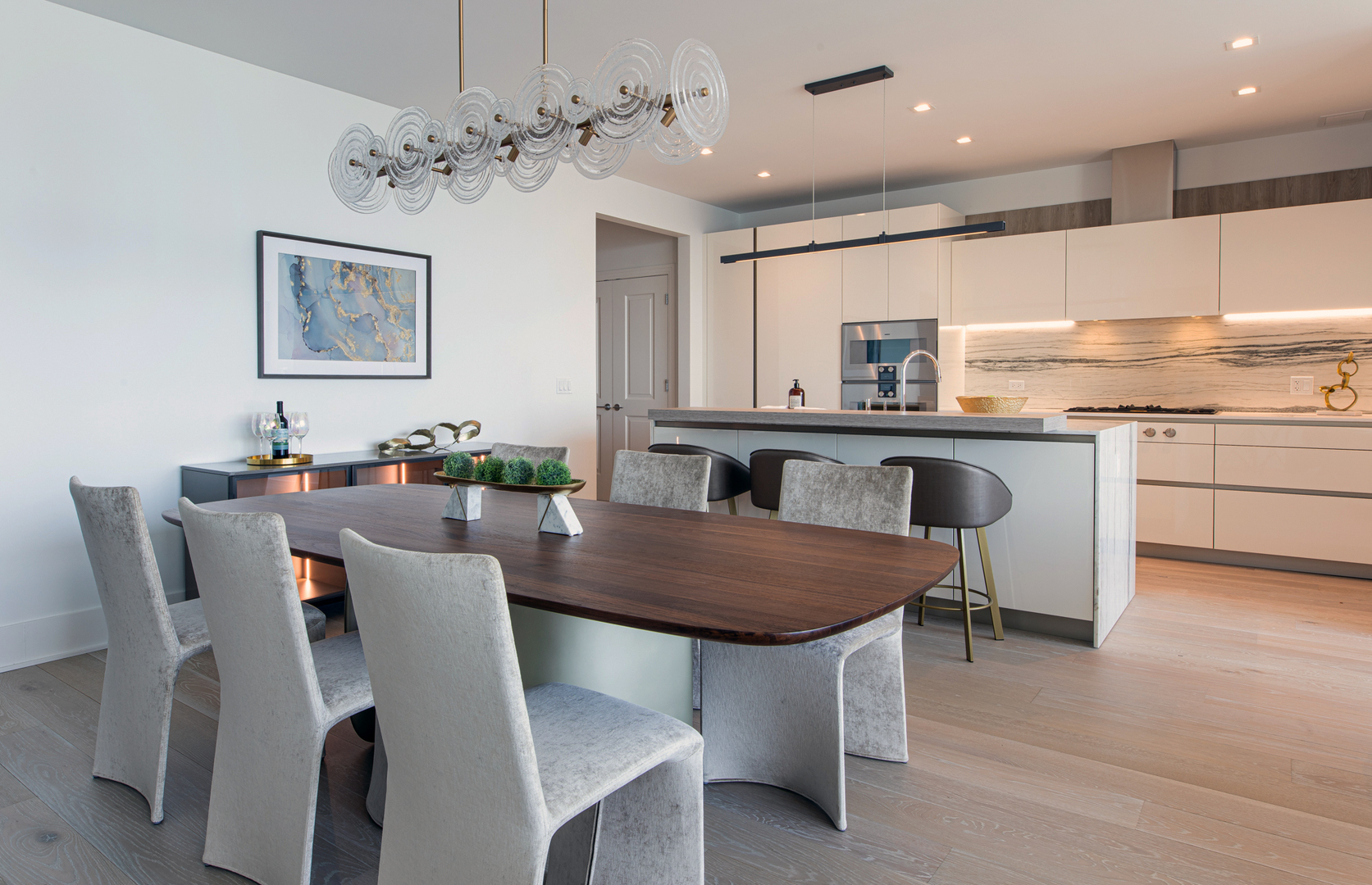 363 East Wacker Drive, Unit 6603 Chicago, IL 60601 - Photo 2 of 21 a kitchen with granite countertop white cabinets stainless steel appliances dining table and chairs