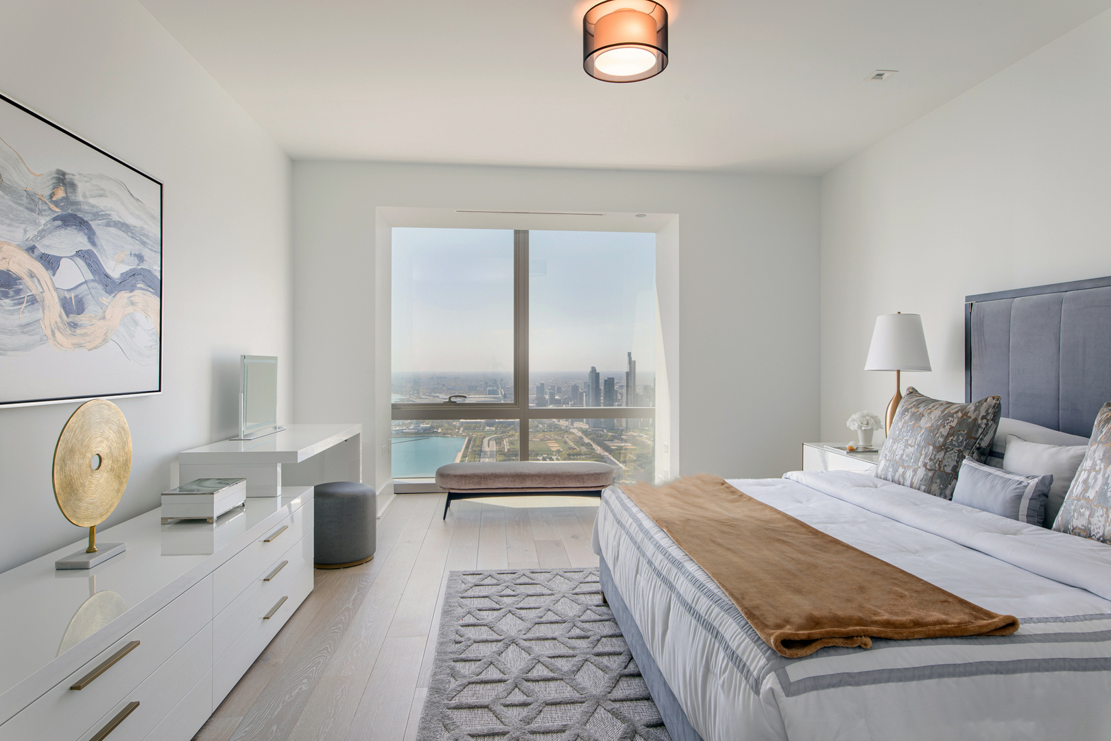 363 East Wacker Drive, Unit 6603 Chicago, IL 60601 - Photo 5 of 21 a spacious bedroom with a bed and glass windows