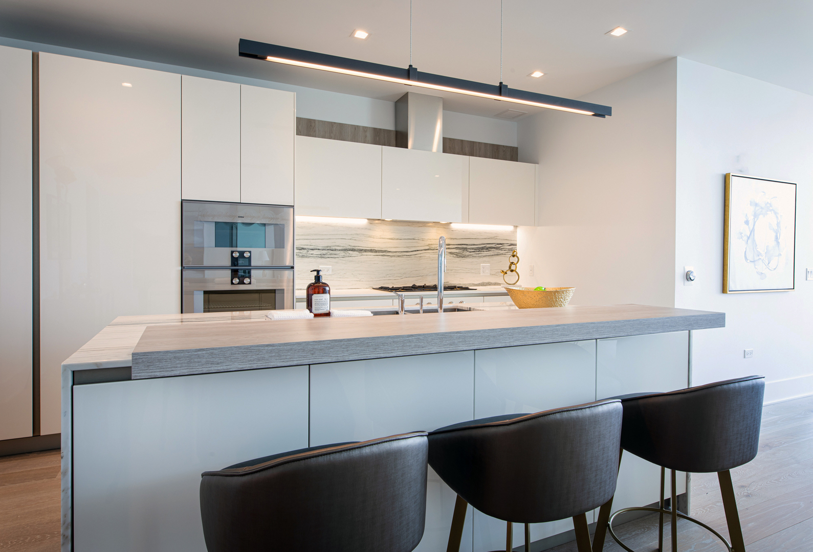 363 East Wacker Drive, Unit 6603 Chicago, IL 60601 - Photo 9 of 21 a kitchen with cabinets and chairs