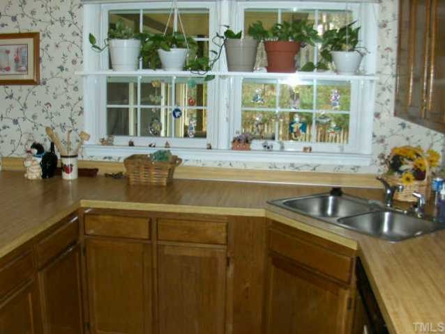 11925 North Exeter Way Raleigh, NC 27613 - Photo 3 of 10 a kitchen with a sink and wooden floor