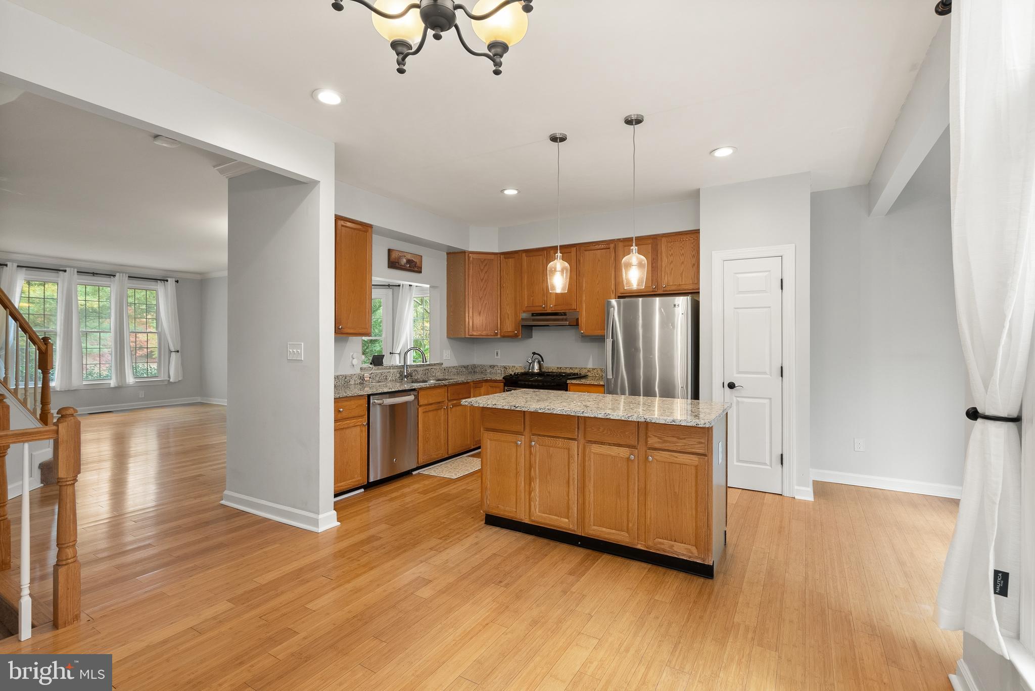 3601 Ransom Place Alexandria, VA 22306 - Photo 18 of 60 a kitchen with stainless steel appliances granite countertop a refrigerator a sink dishwasher a stove and white countertops with wooden floor