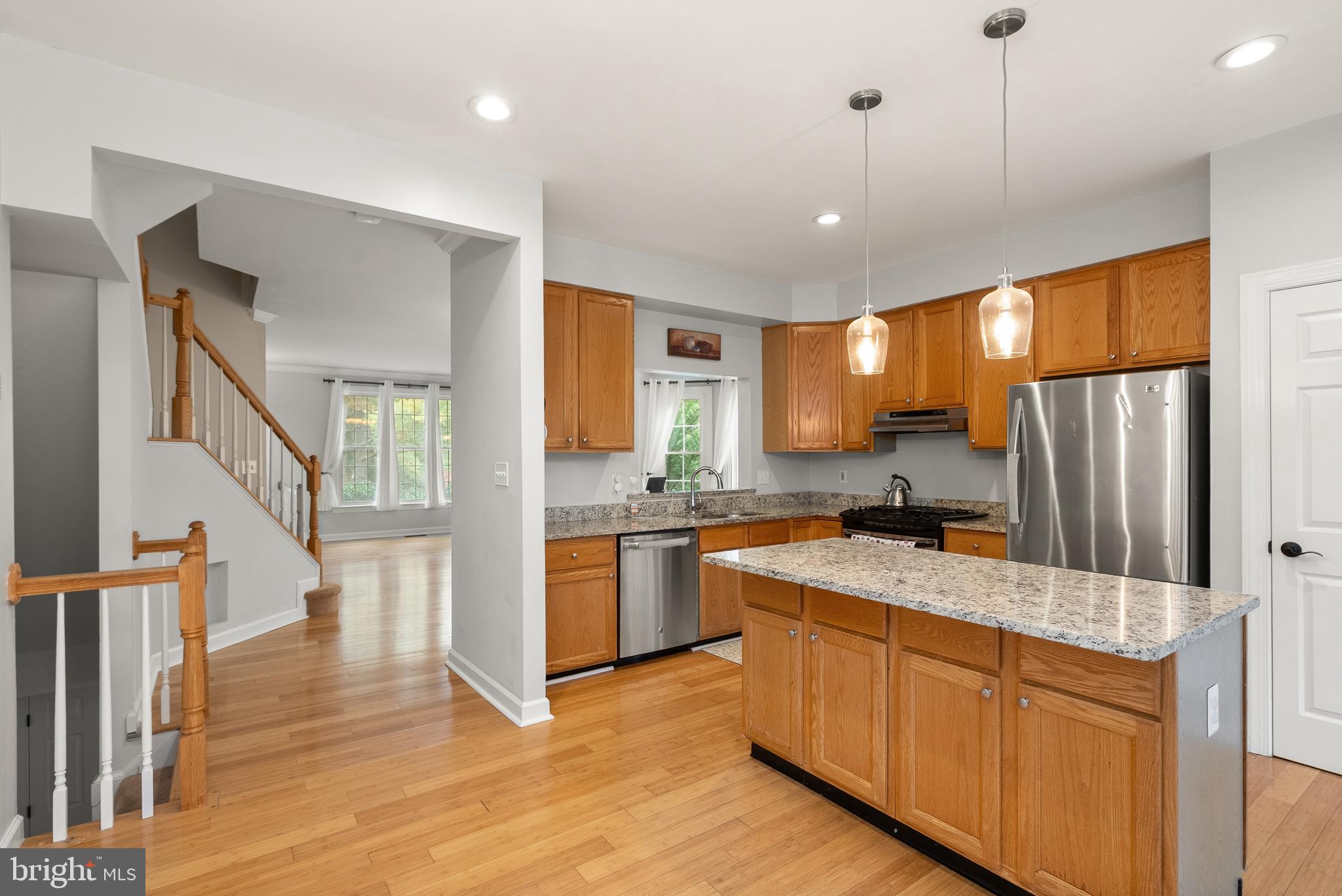 3601 Ransom Place Alexandria, VA 22306 - Photo 19 of 60 a kitchen with stainless steel appliances granite countertop a refrigerator a sink dishwasher a stove and white countertops with wooden floor